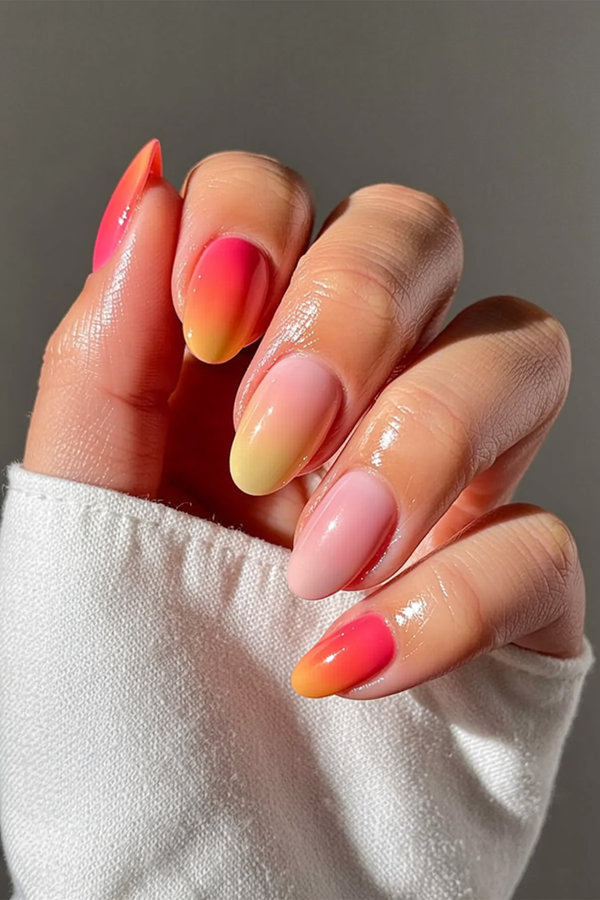 18 Sunset gradient nails fading from deep coral to golden yellow to soft rose_bp