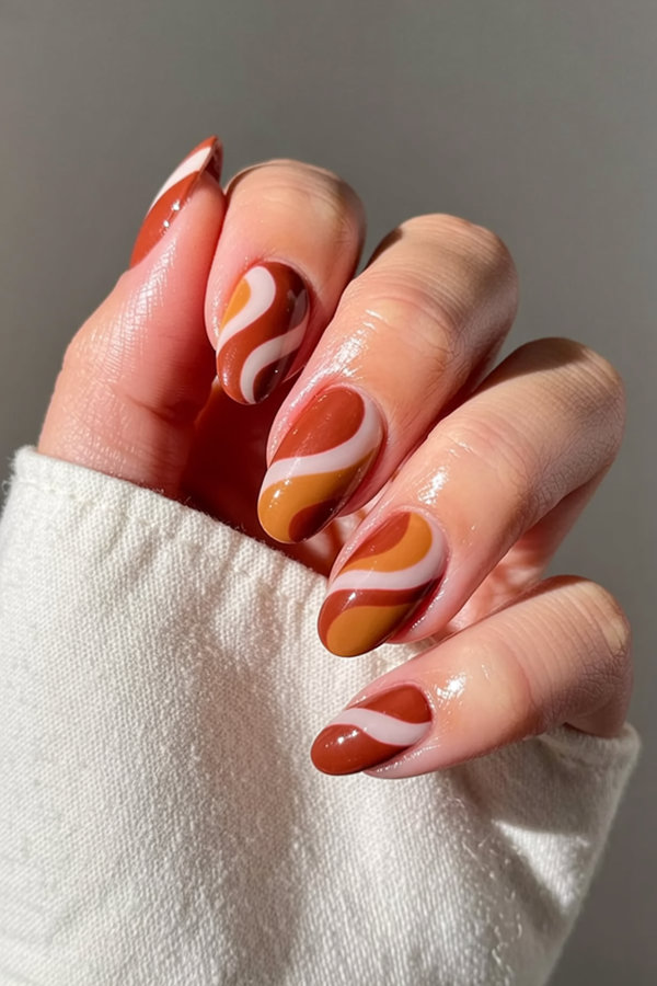 24 Retro 70s-inspired swirl nails in terracotta, burnt orange, and cream_bp