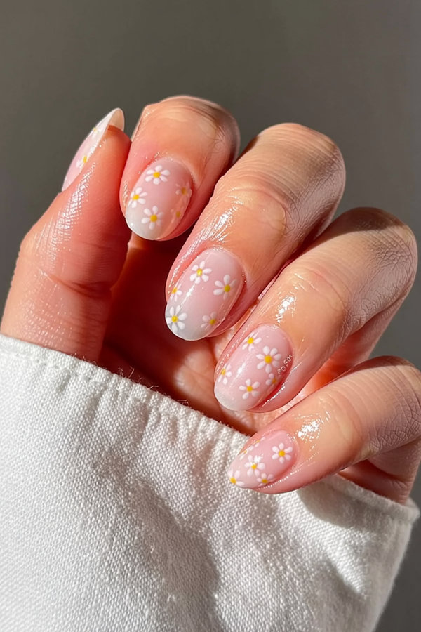 33 Micro floral nails featuring tiny hand-painted daisies scattered across a milky white base_bp